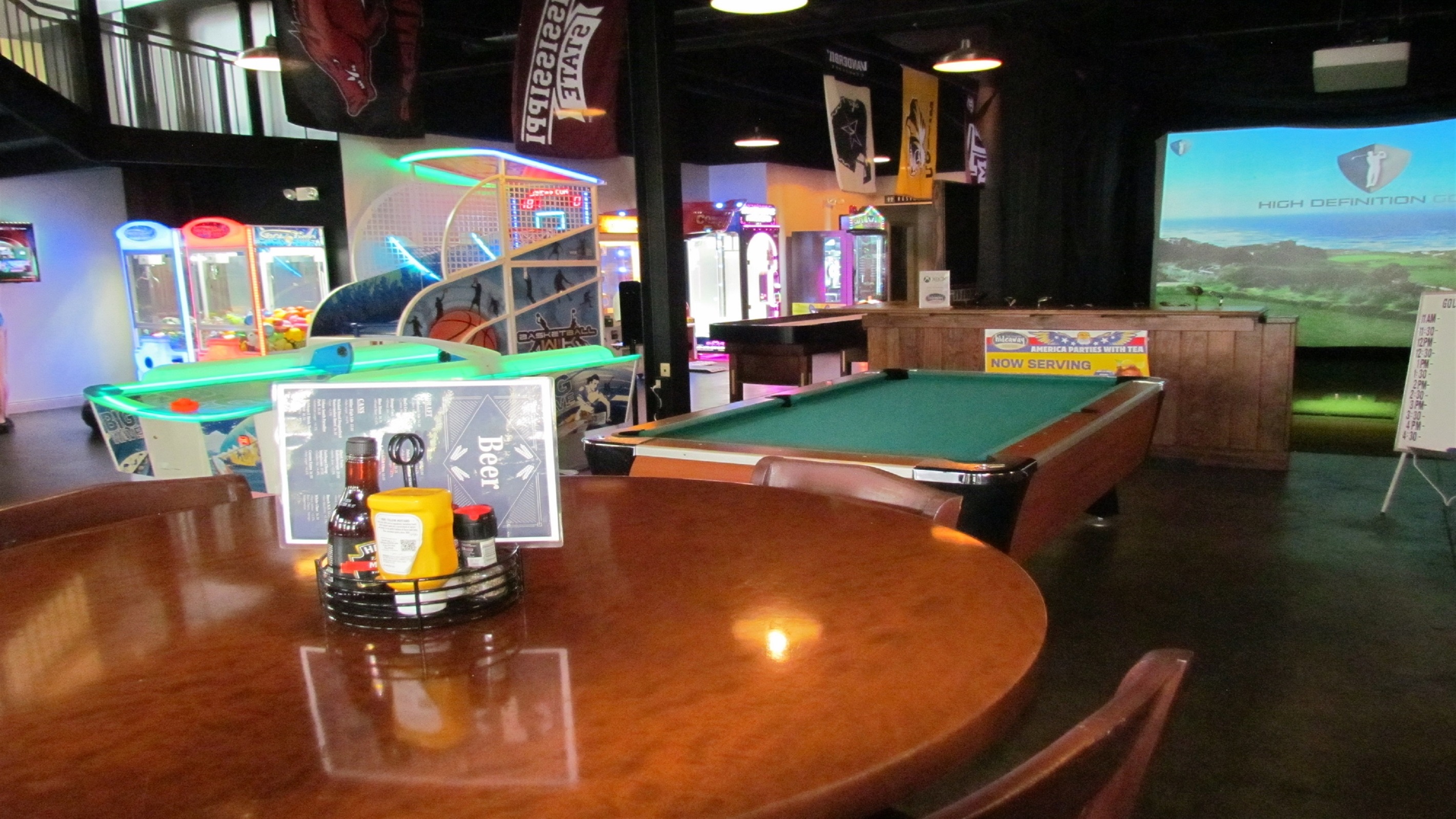 Unleash your inner gamer at the Village Hideaway's vibrant arcade, featuring a wide array of classic and modern games including basketball, shuffleboard, and more, for endless family fun.