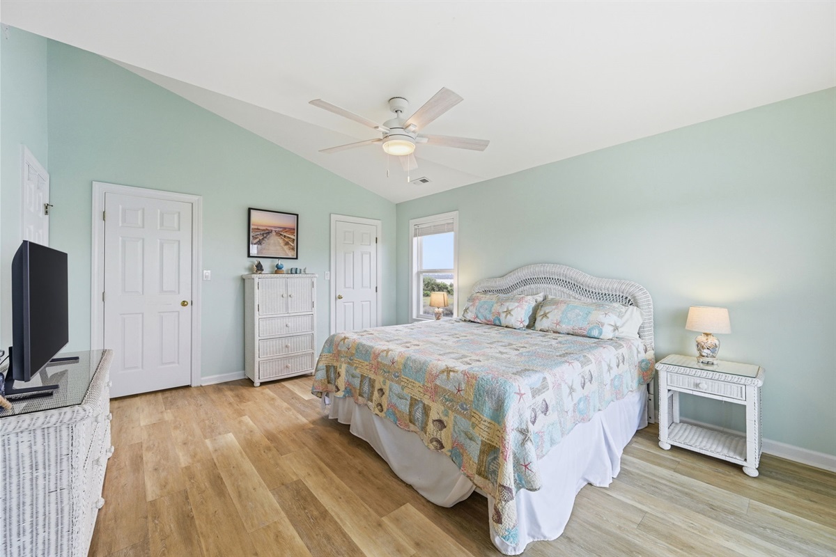 King suite with TV entertainment and generous closet & storage space—designed for a comfortable, clutter-free stay.