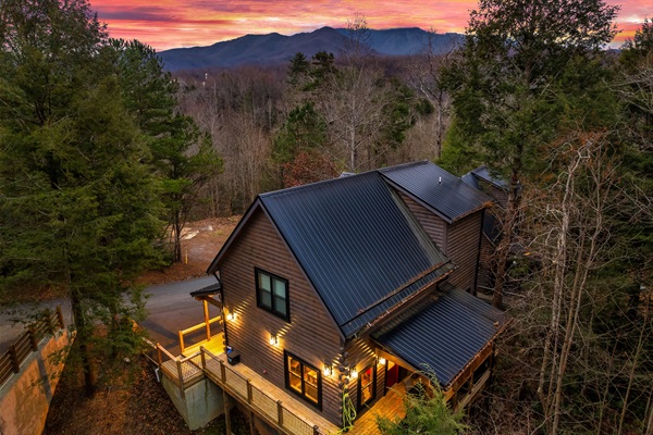 Exterior: Embrace mountain sunsets from your private deck in this charming log cabin!