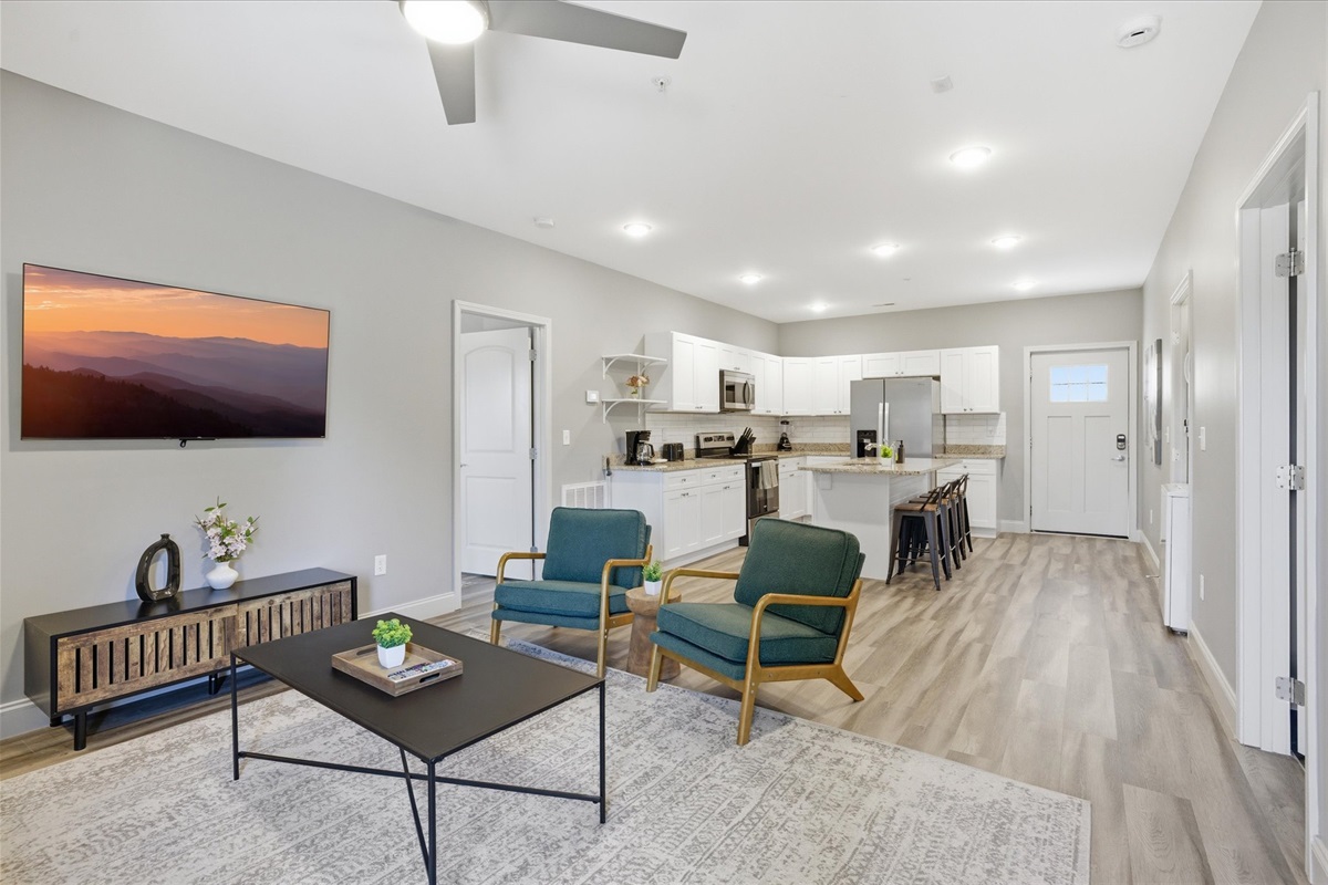 From this view in Unit 2, you can see how the space opens up—plenty of seating, a TV for winding down, and a layout that keeps everything feeling connected.