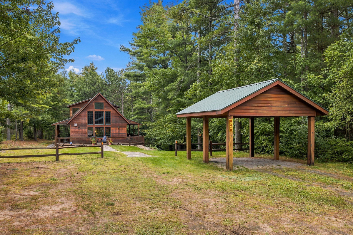 Covered outdoor carport for one car.  Additional parking is located to the left of the carport. 