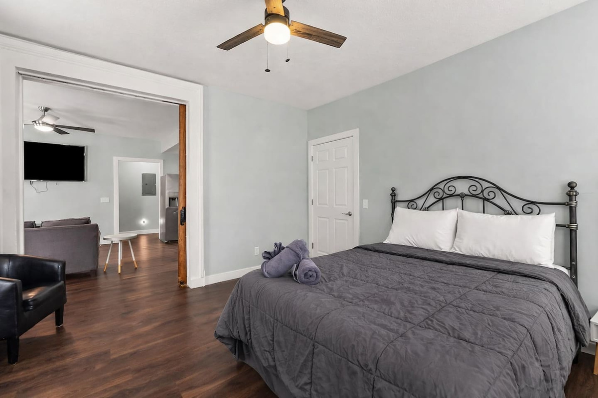 Primary bedroom with elegant antique pocket door access, connecting seamlessly to the living area.