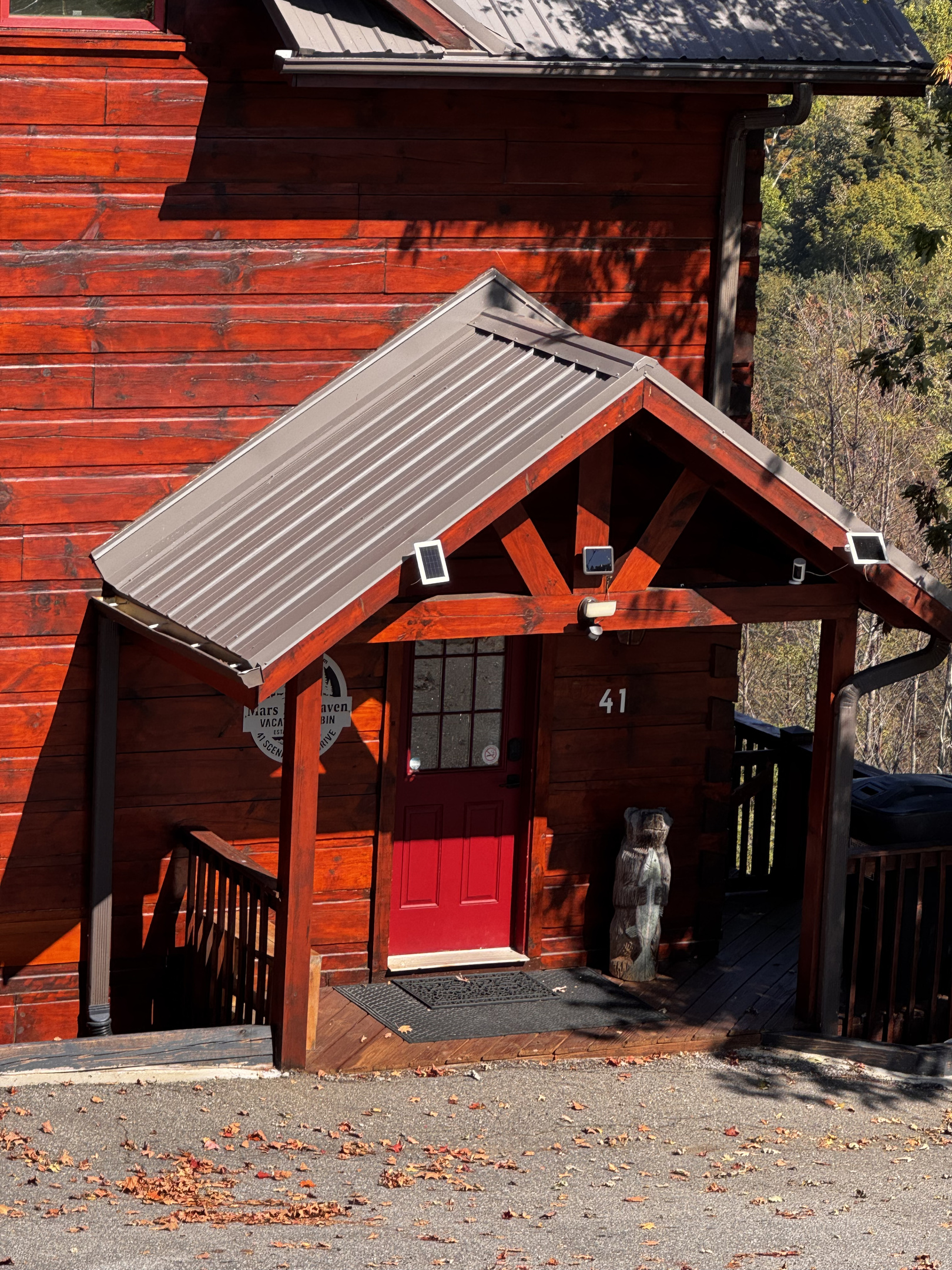 A closer look at the log cabin exterior and covered front entrance.