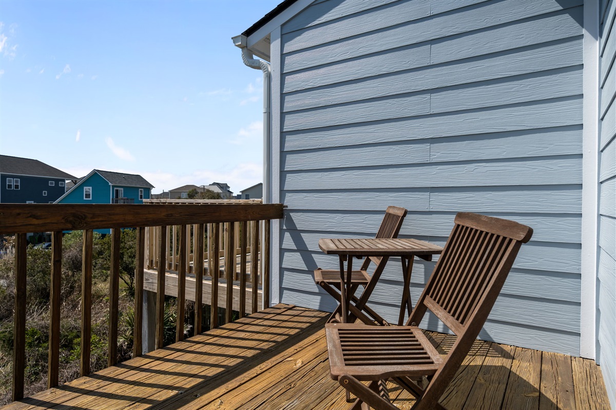 Small deck seating area with table and chairs