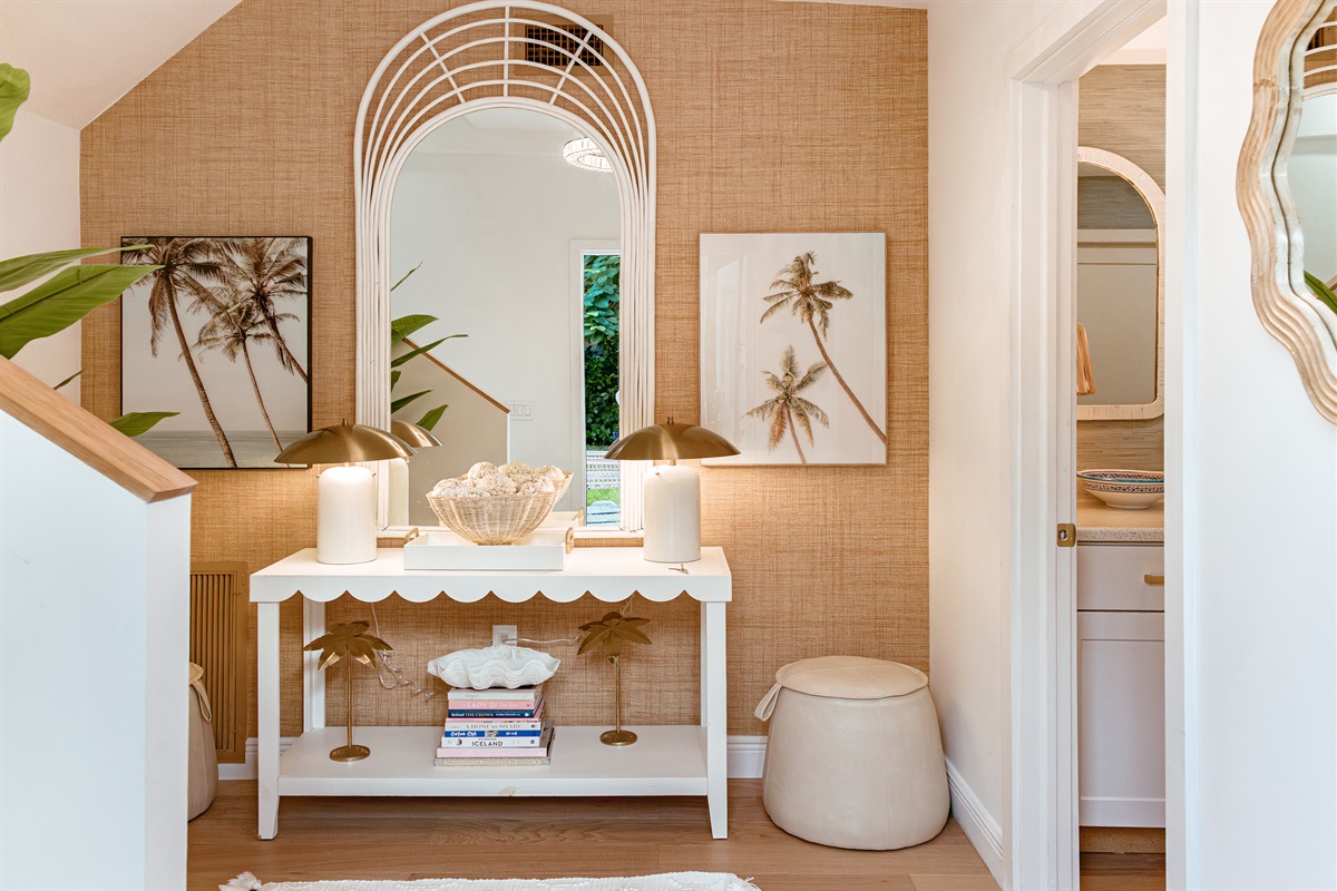 As you enter the cottage, you're greeted with an accent wall that highlights Palm Beach vibes.