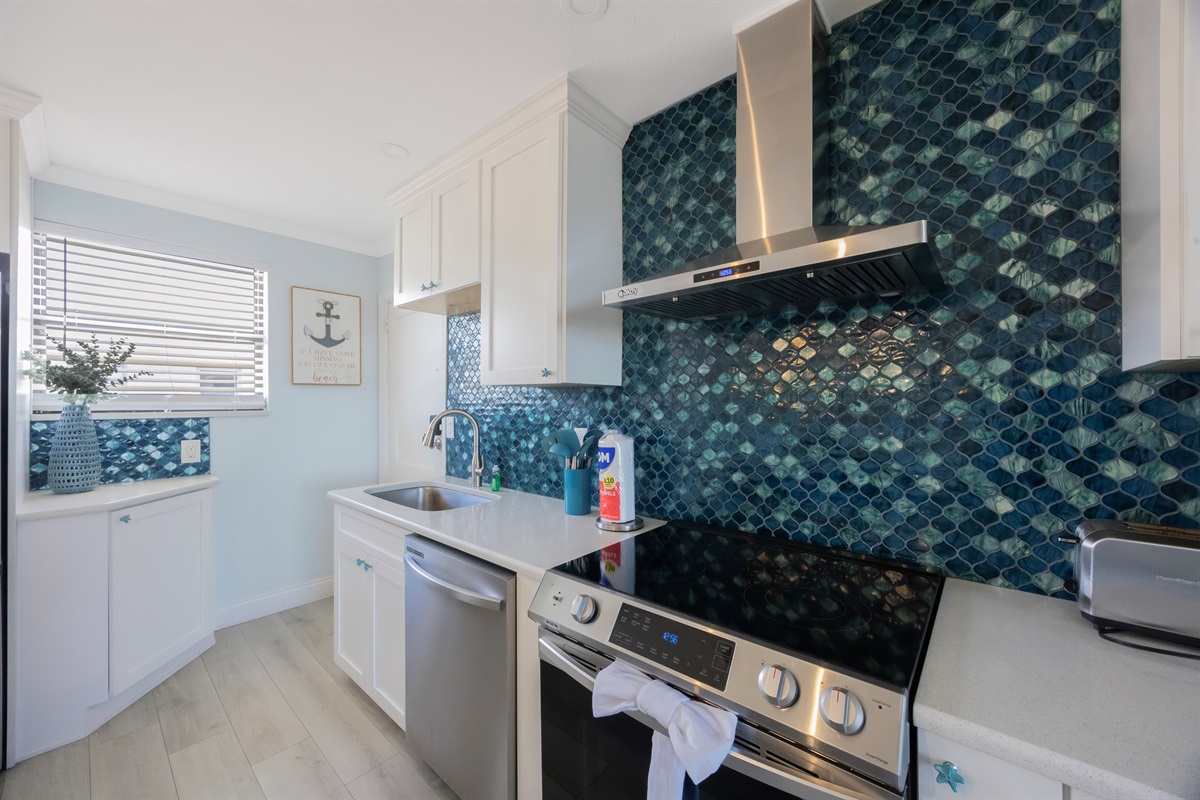 Kitchen stocked with cooking/eating/drinking utensils