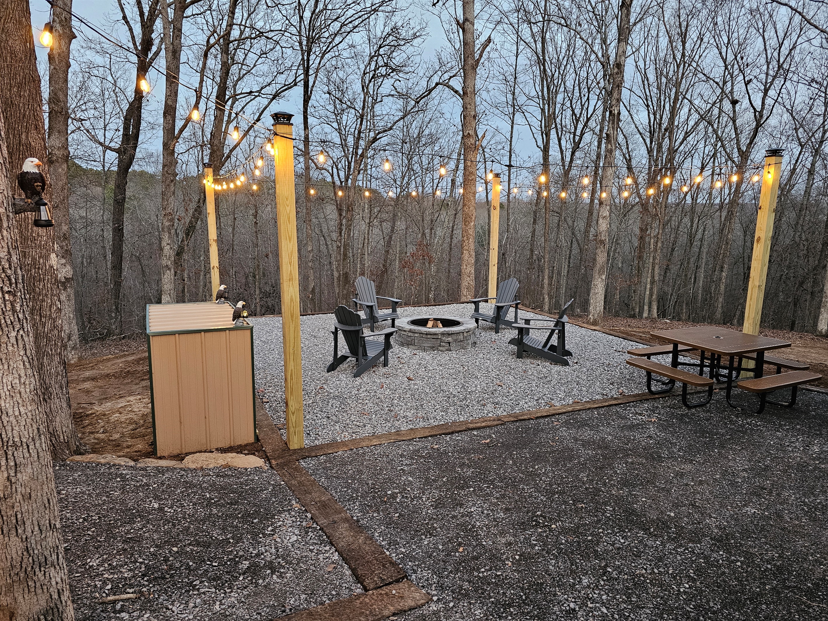 Spend golden-hour evenings by the fire pit under café lights, with Adirondack seating and a nearby picnic table—perfect for relaxed family moments or quiet, romantic nights wrapped in nature a