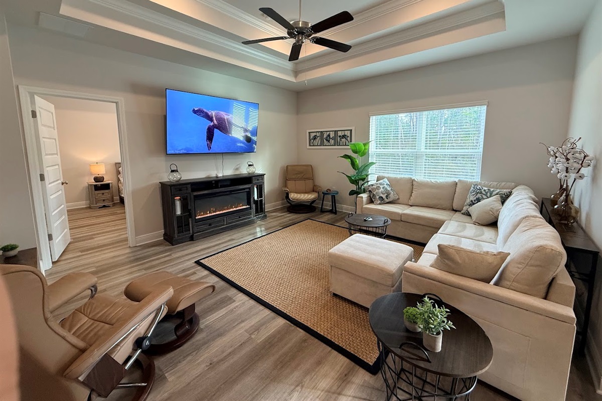 Open‑concept living room with plush seating and a large Smart TV — perfect for movie nights.