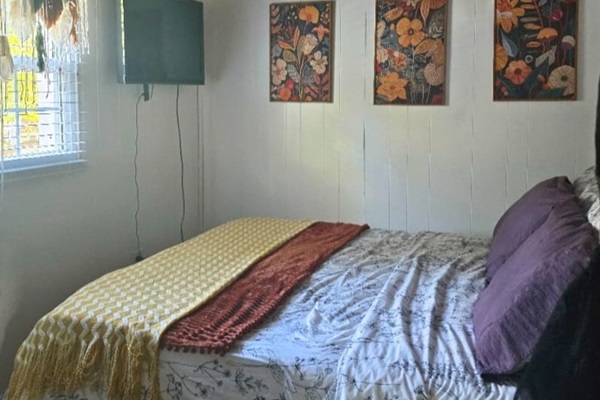 Granary‑house‑second‑bedroom‑tv‑floral‑art