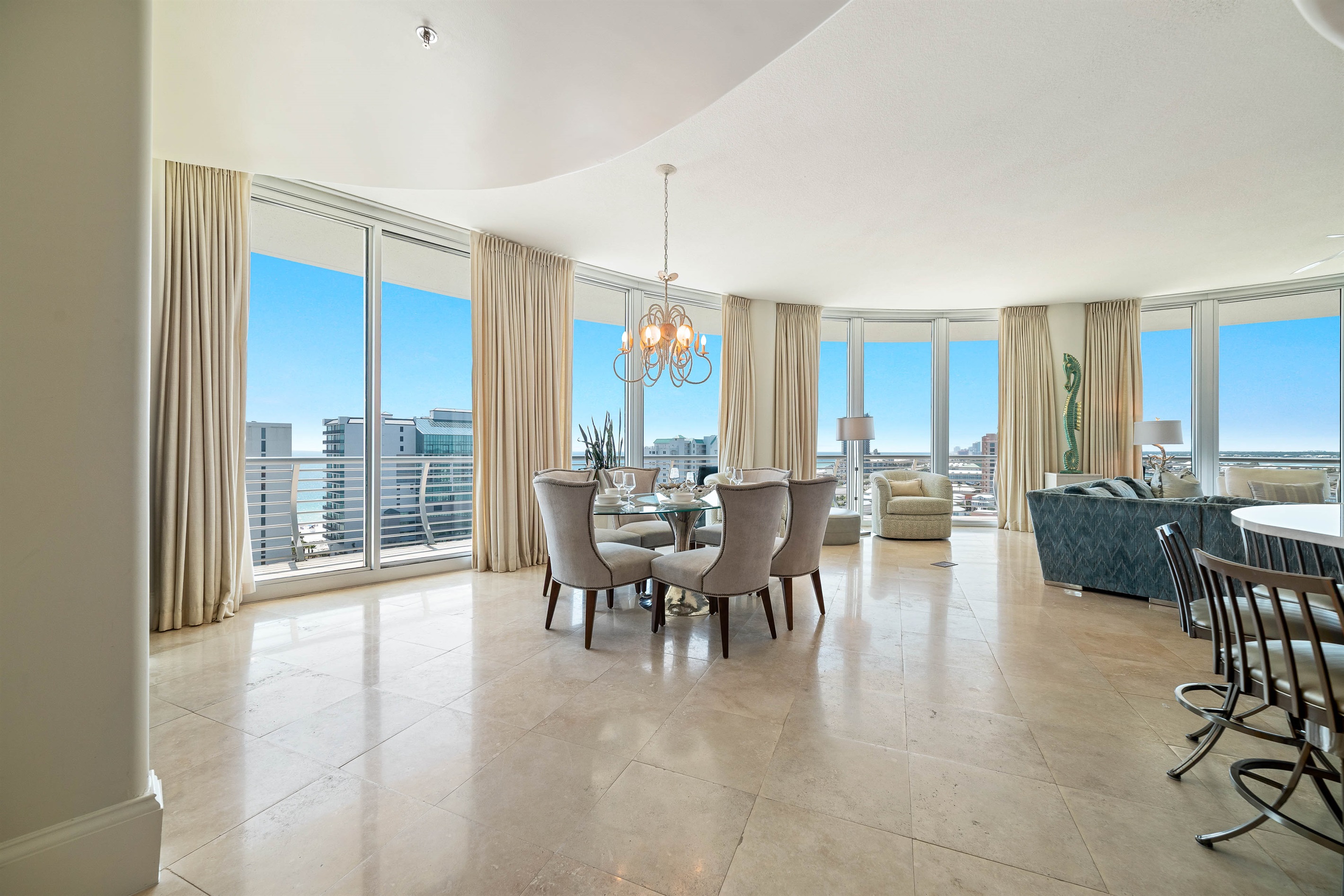 Indulge in sophisticated dining with an unparalleled backdrop. This elegant 6-seater space, featuring a stunning chandelier and polished stone flooring, is perfectly framed by floor-to-ceiling windows offering a captivating view of the Ole River.