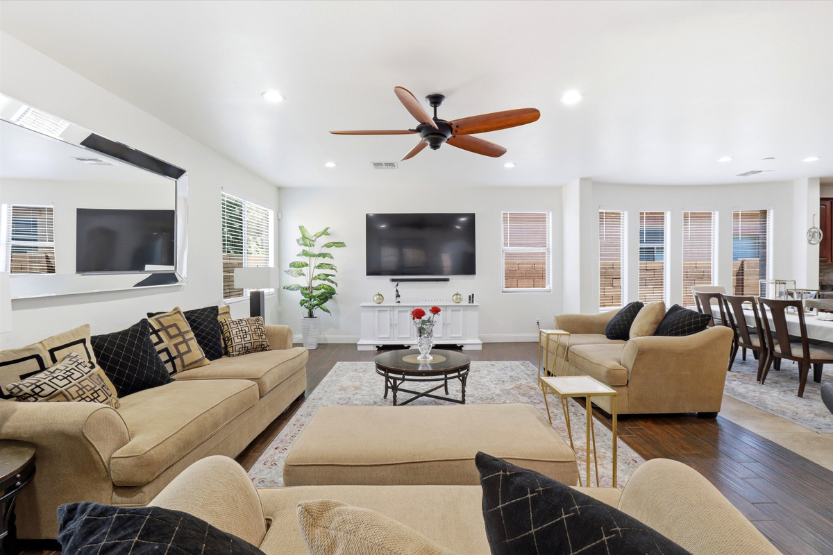 Living room with plenty of seating, a large TV, and an open dining area for everyone to gather.
