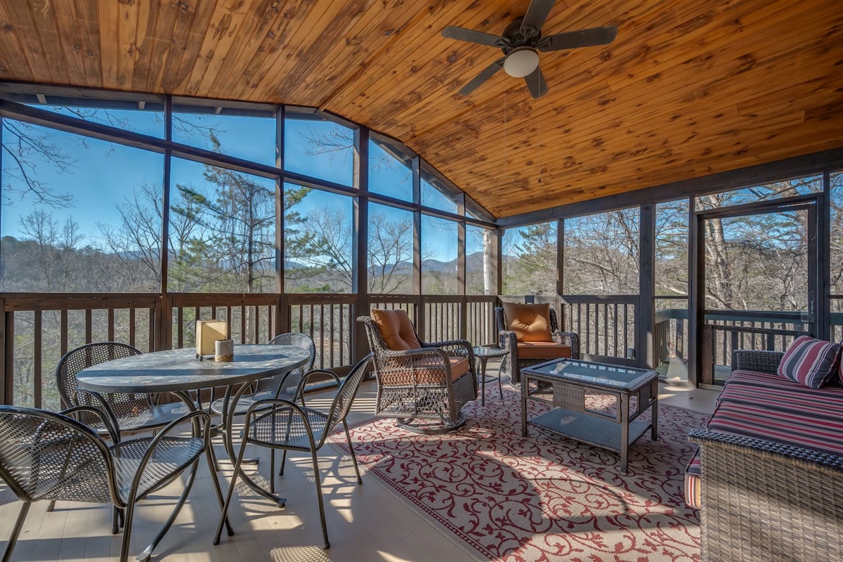 Main level deck of the cabin with plenty of seating and a screened in porch for comfort!