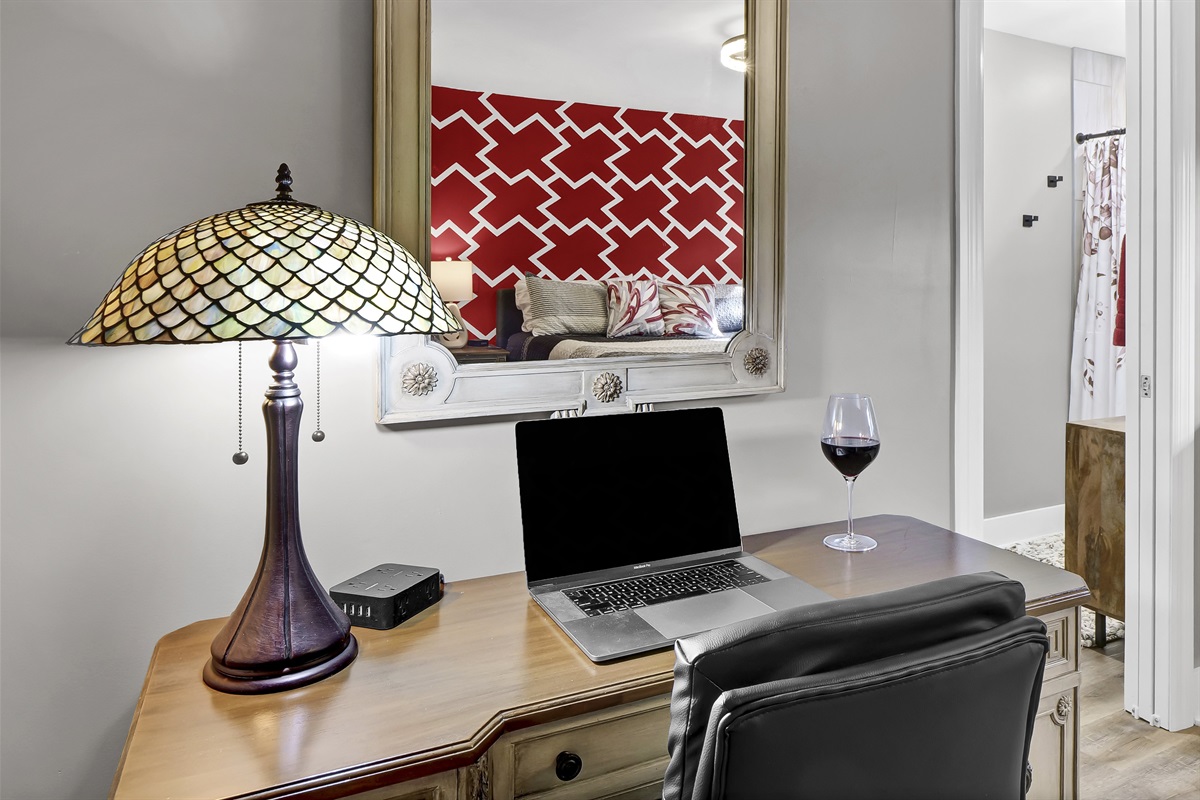 Comfortable workspace featuring an ergonomic desk and high-speed internet.