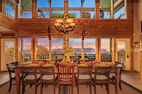 Great Room dining table for 12, with sunset through the windows, Tanasi Lodge