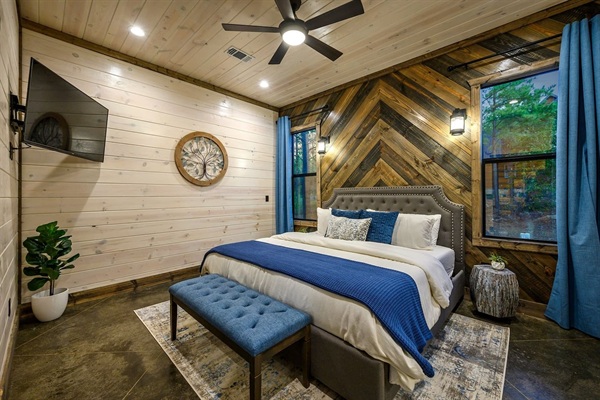 King Suite 1 with TV, nightstands, room darkening curtains, and a closet