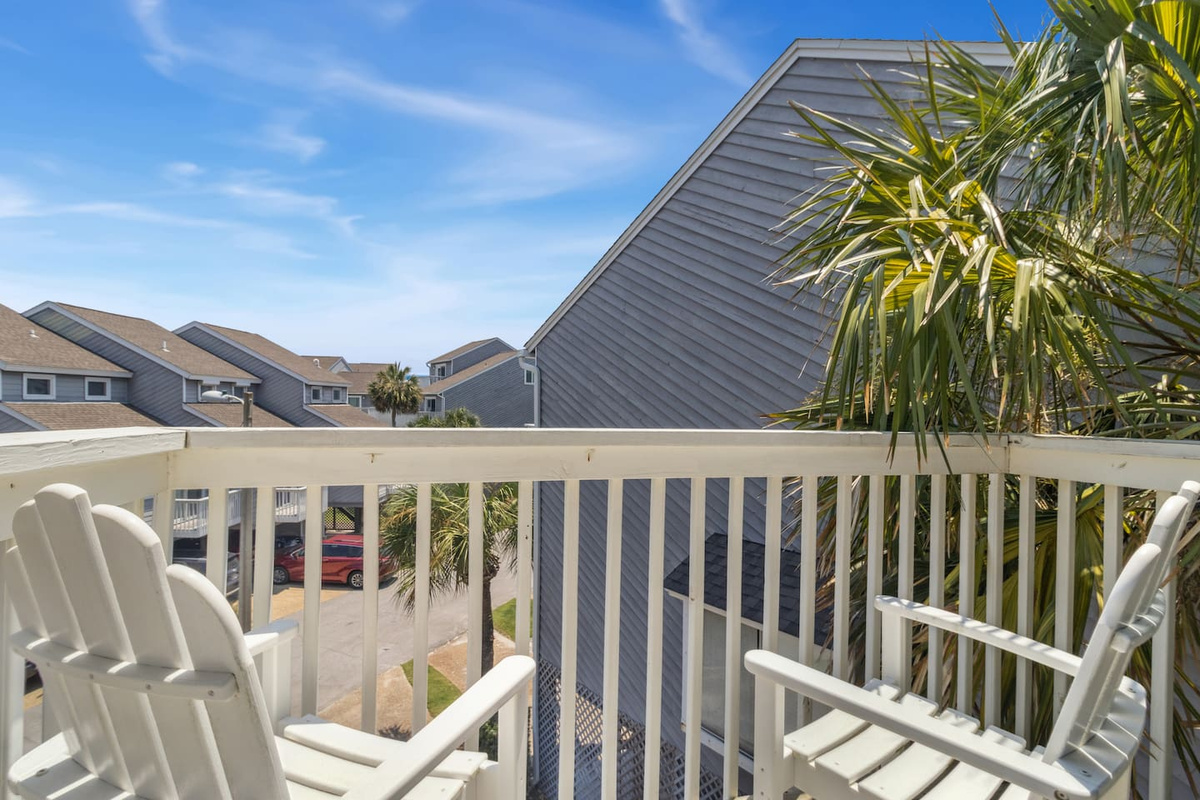 The tropical balcony off suite two &mdash; lush, private, and a completely different vibe from the Gulf-view deck.