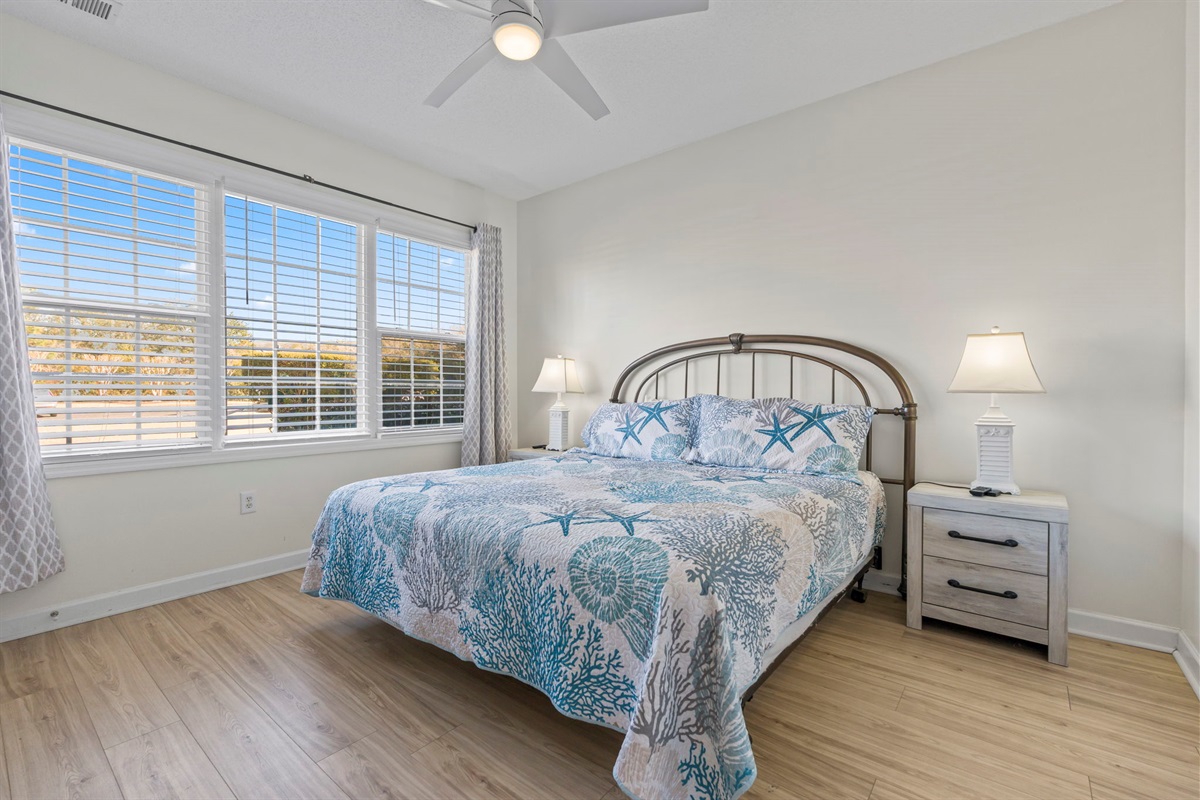 Master Bedroom with large window, king bed, ensuite bathroom