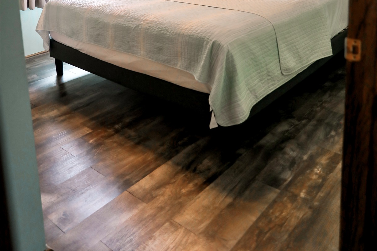 [Bedroom #1] King bed with TV and half bathroom.