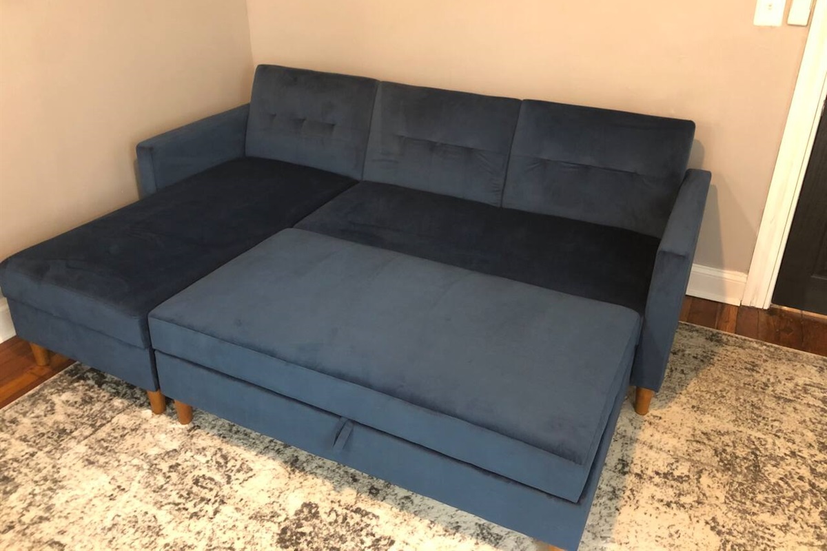 Couch & Ottoman w/ storage. Converts to a queen size bed!