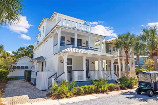 Bright 3-story home with separate carriage house, multiple porches and walkable access to the beach, pool, green space, restaurants and shops.
