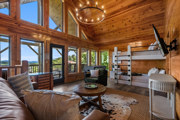 Upstairs game room with full-over-full bunks, TV, and mountain views