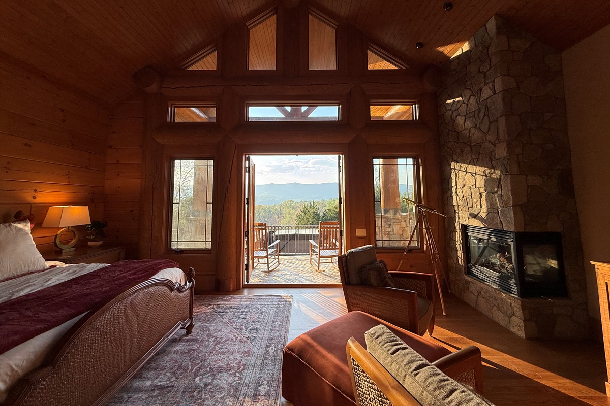 Spacious master bedroom featuring a comfortable king bed and a cozy propane fireplace