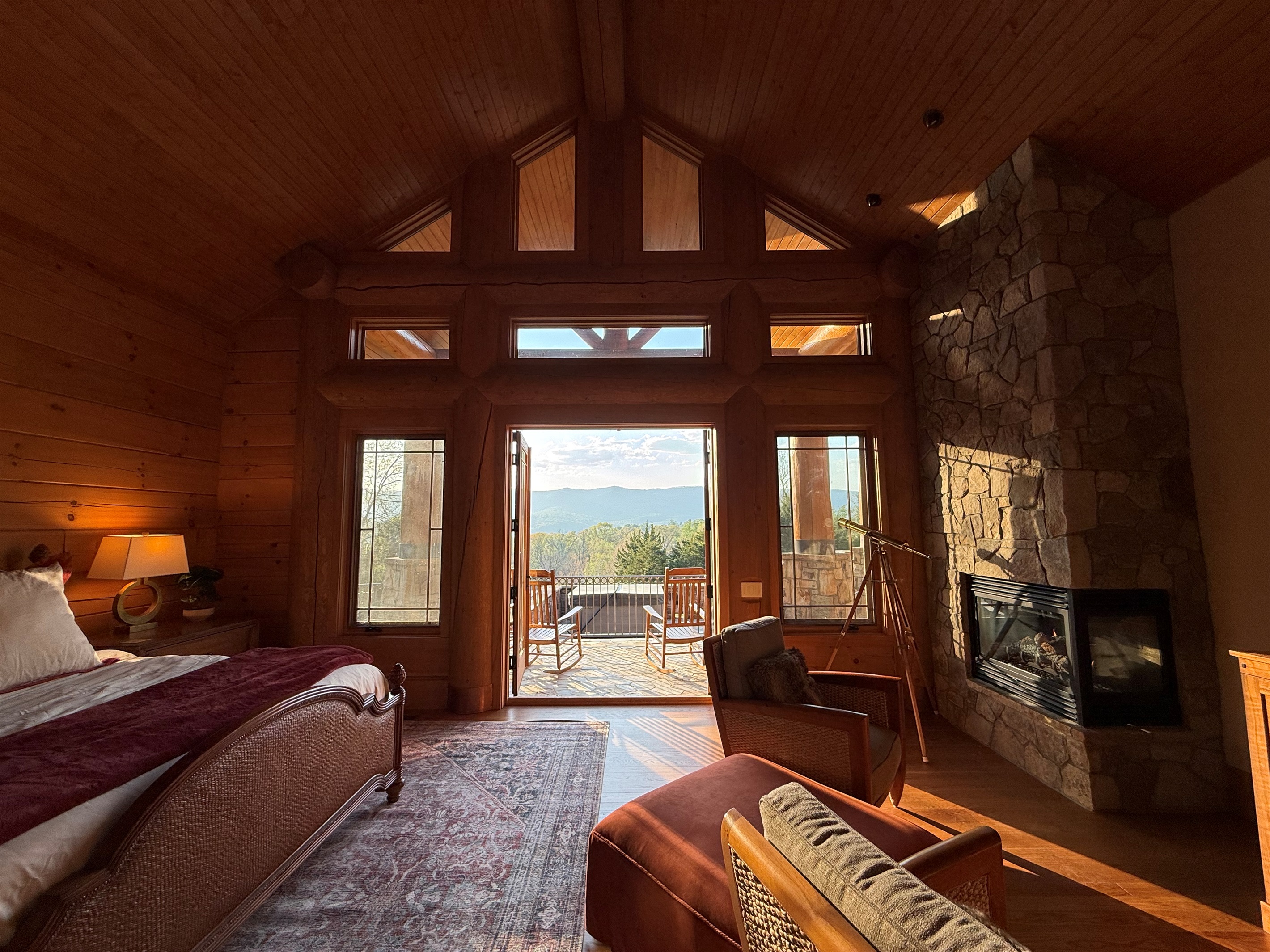 Spacious master bedroom featuring a comfortable king bed and a cozy propane fireplace