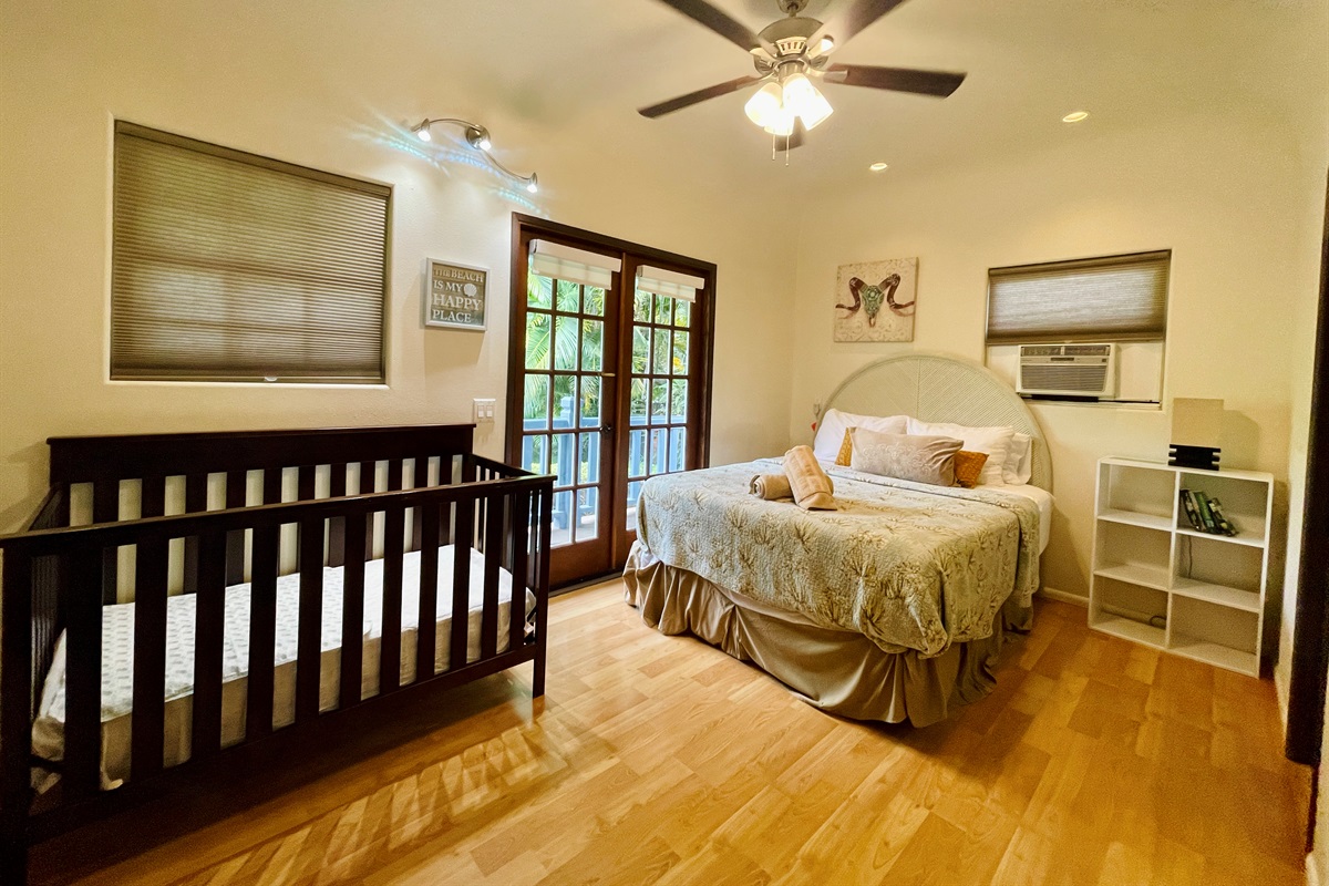 Bedroom 2: a queen bed and a crib