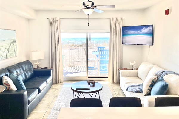 Living room with sleeper sofa, a 2nd sofa, smart TV, ceiling fan and balcony access