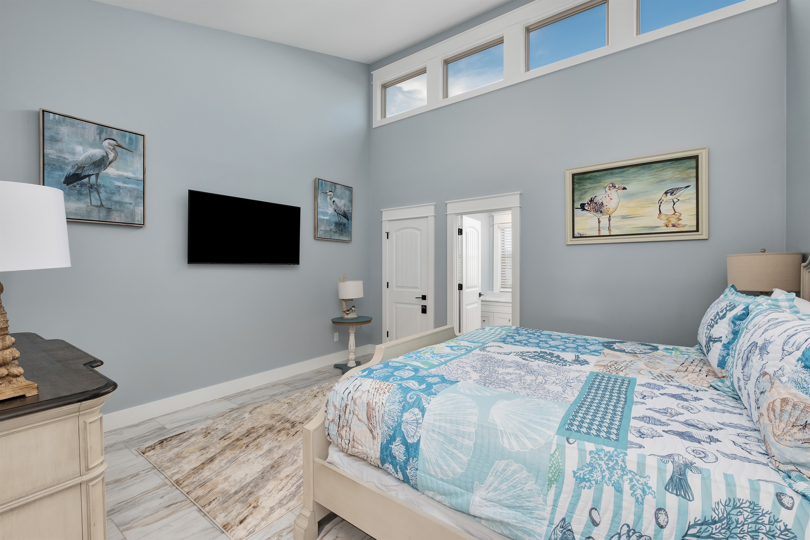 Enjoy the stylish bedroom adorned with beach-themed decor and an ensuite bathroom.A perfect retreat after a day at the beach.