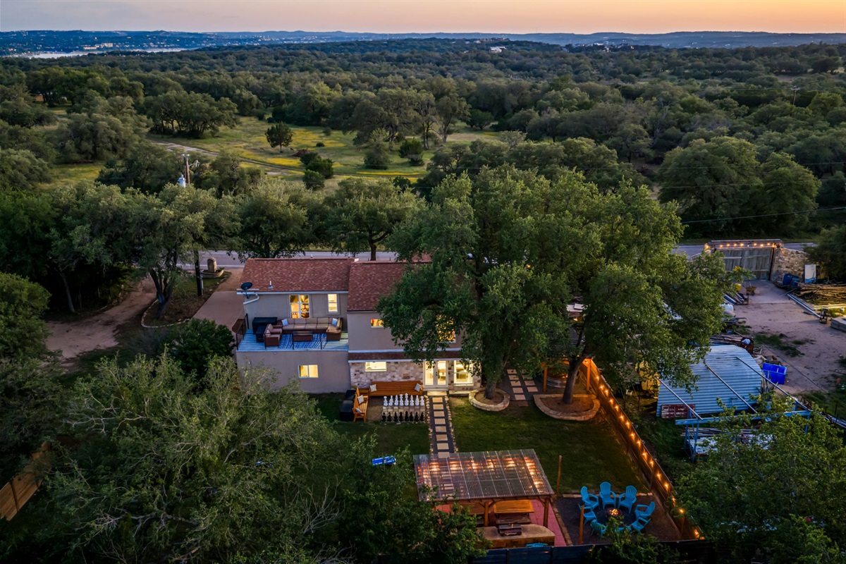 Enjoy peaceful Hill Country views from this private retreat featuring a spacious backyard, balcony lounge, fire pit area, and covered BBQ space. Perfect for relaxing group getaways, outdoor fun, and memorable evenings together.