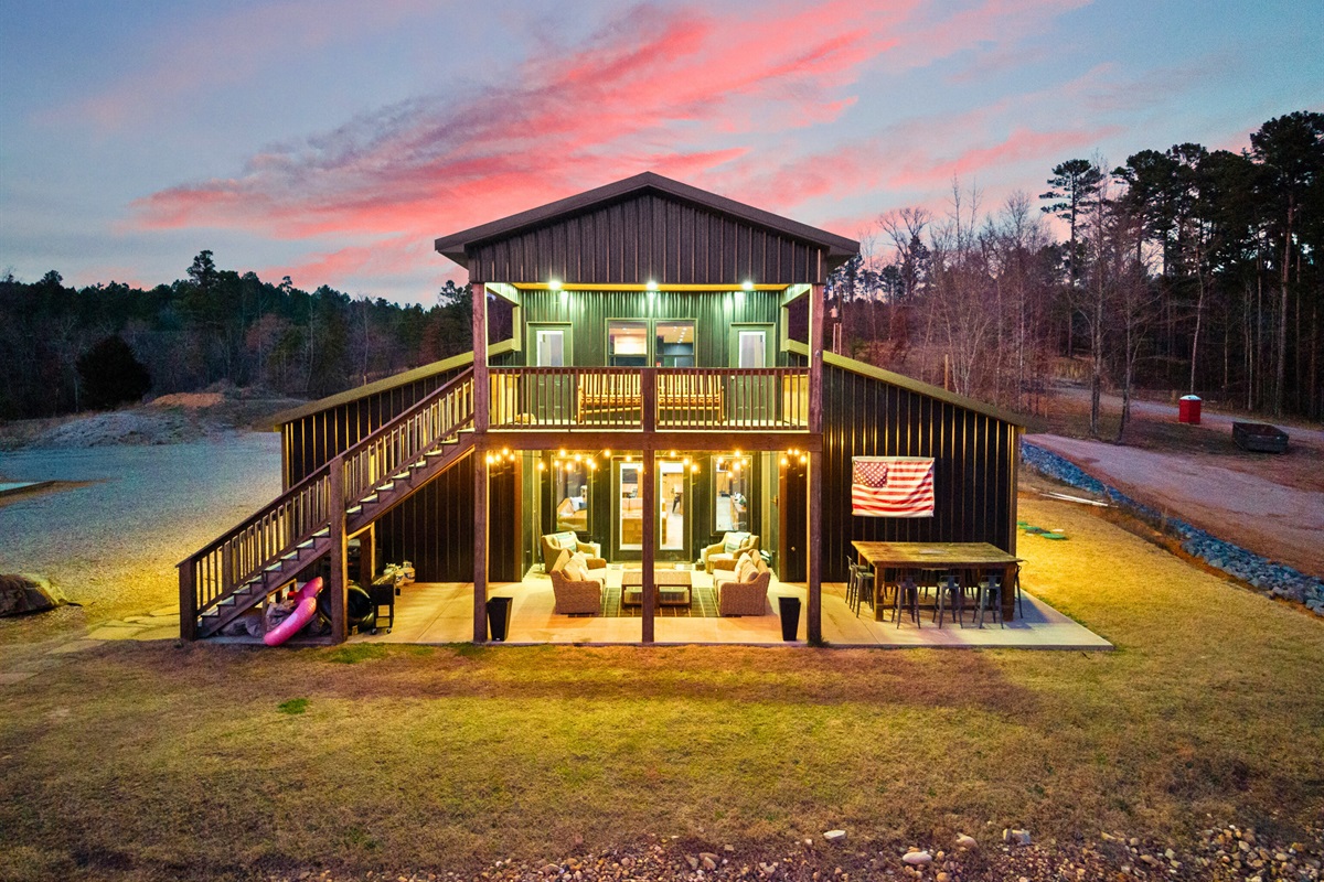 Large windows and warm lighting give the home a welcoming glow as day turns to night.