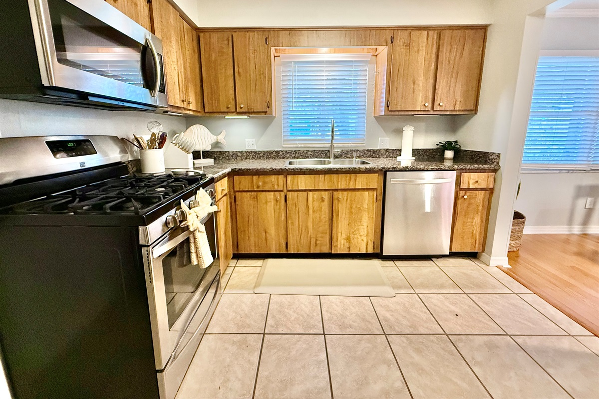 Granite countertops, gas stove, and dishwasher make cooking and cleanup a breeze in this practical space.