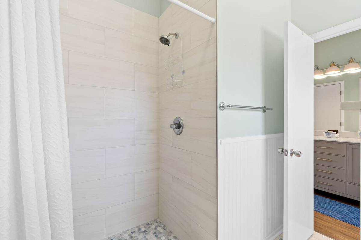 Your tile shower was recently updated &mdash; clean lines, good pressure, and enough room to actually enjoy a post-beach rinse.