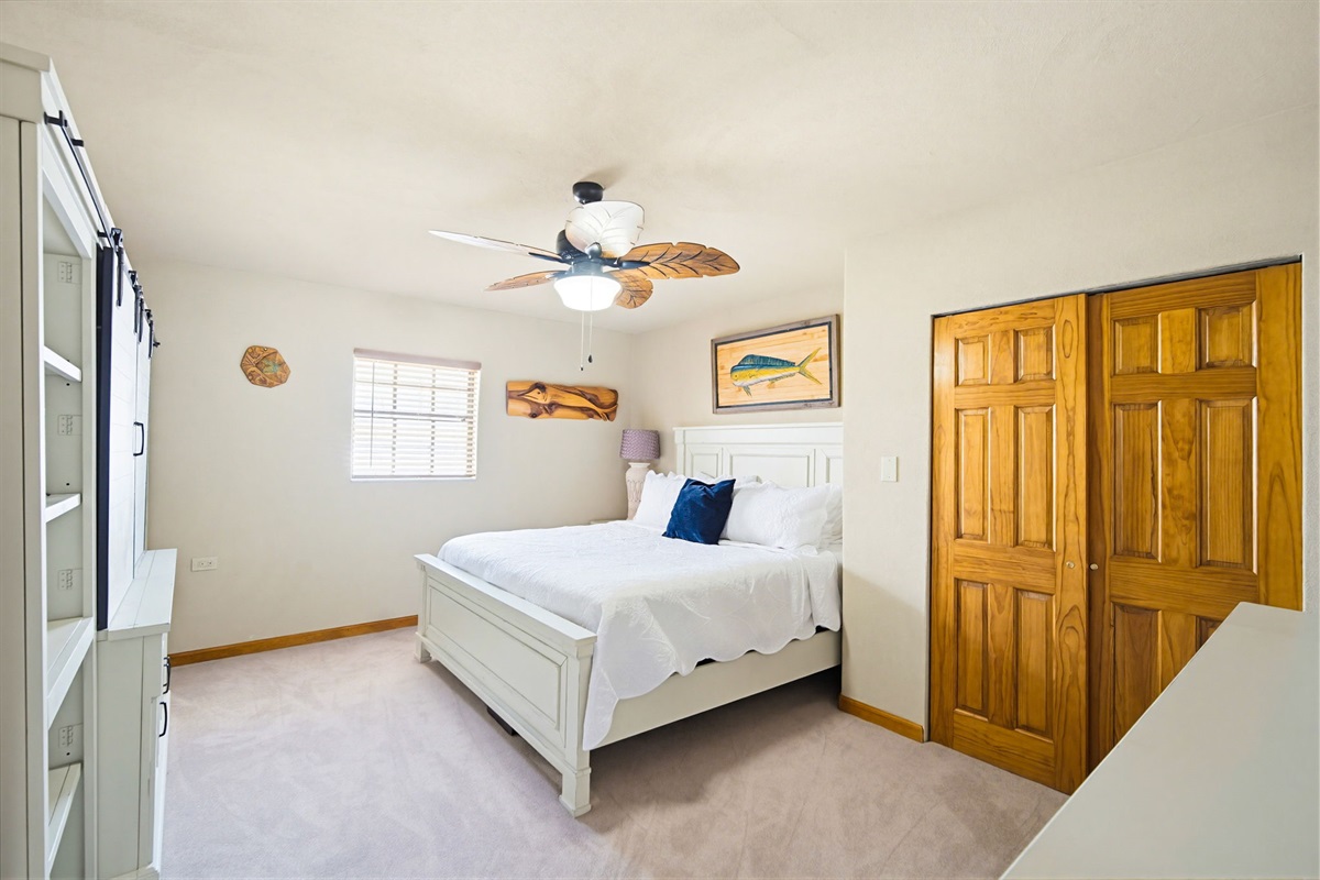 A third bedroom, with a King Bed and 65 inch TV.