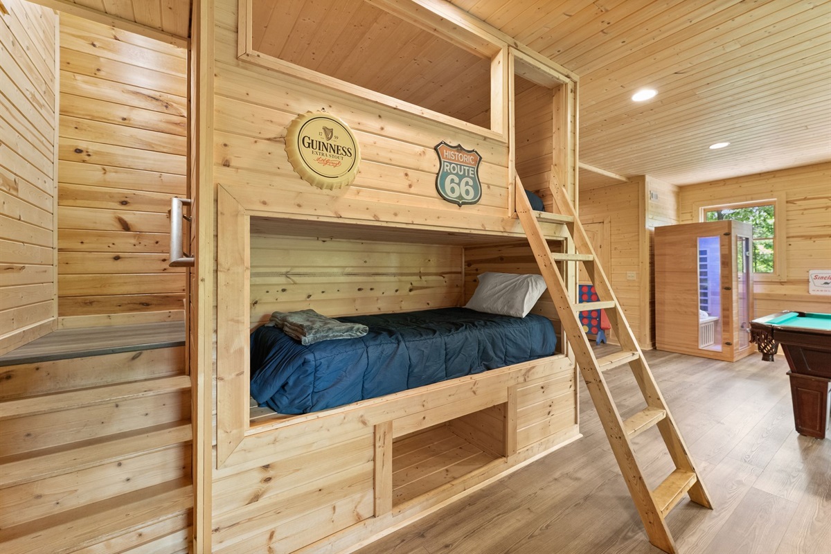 Lower-level open sleeping area with twin bunk beds, perfect for kids, friends, and fun cabin sleepovers.