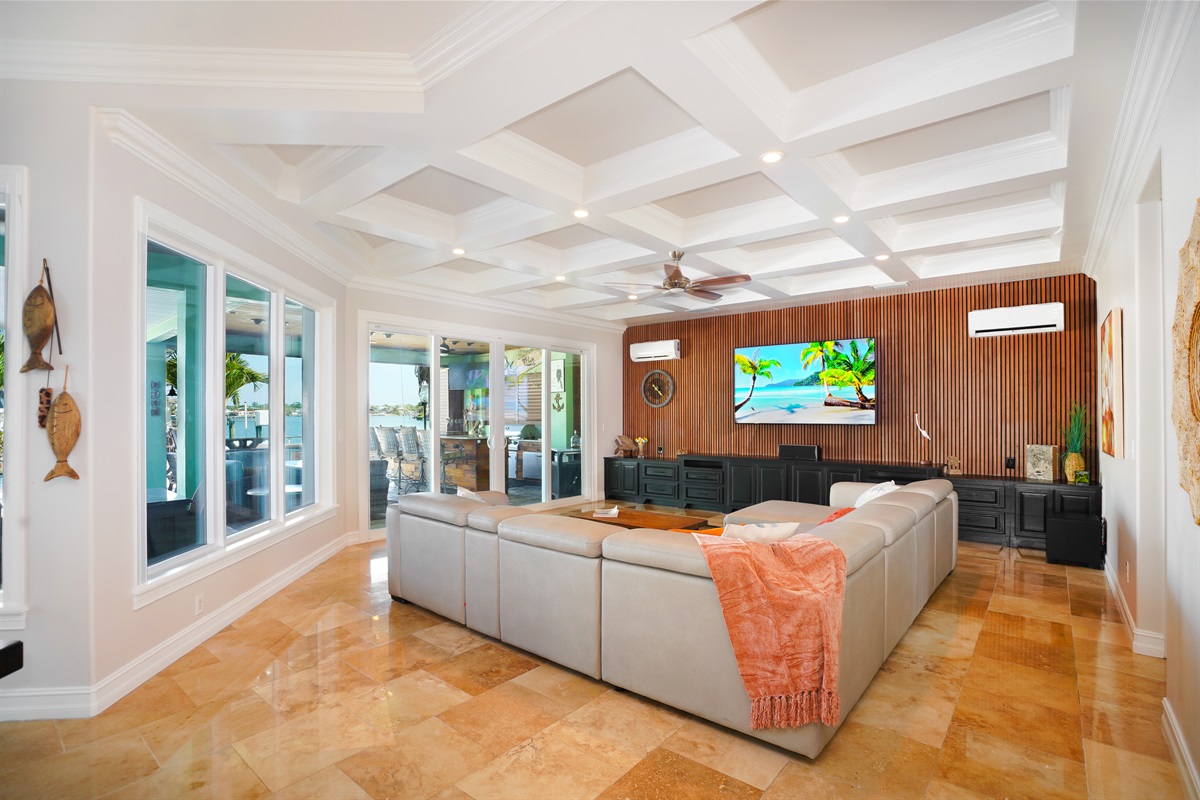 Ground floor living room opens to the outdoor kitchen and overlooks the pool and ocean.