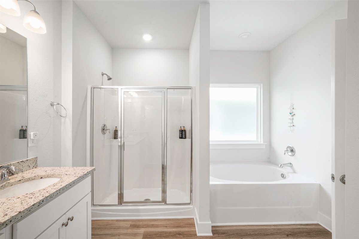 Primary bathroom: Dual sinks, tub and walk-in shower, perfect for busy mornings