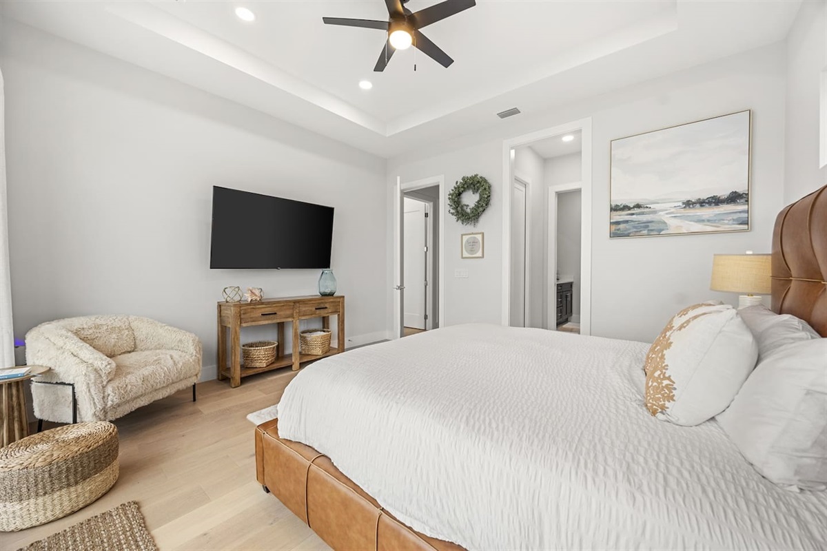 The master bedroom features a comfortable king bed and an attached ensuite bathroom, providing guests with a private, luxurious space to unwind.