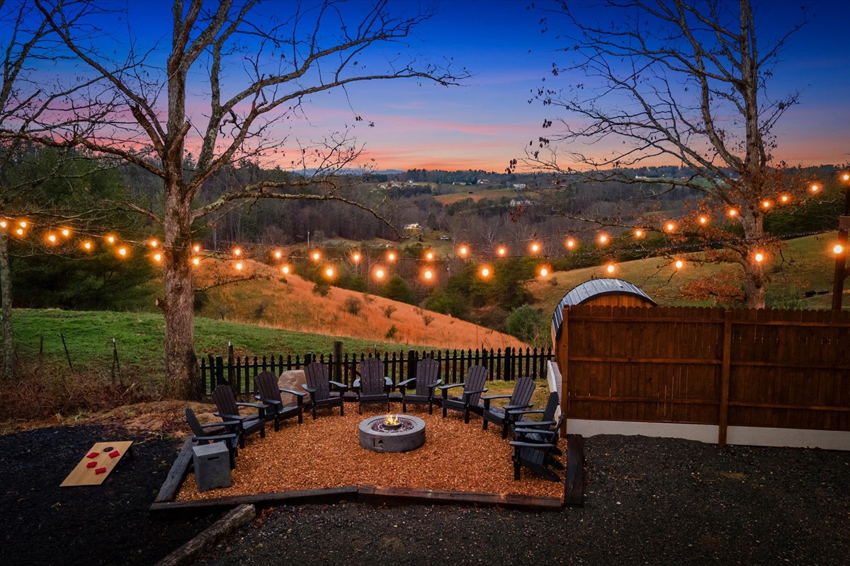 {Gather} Outdoor gathering space with fire pit, string lights, and mountain backdrop — designed for memorable evenings.