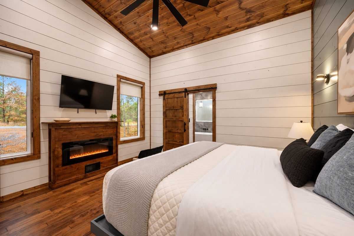 Curl up under soft bedding while the fireplace brings a gentle evening glow.