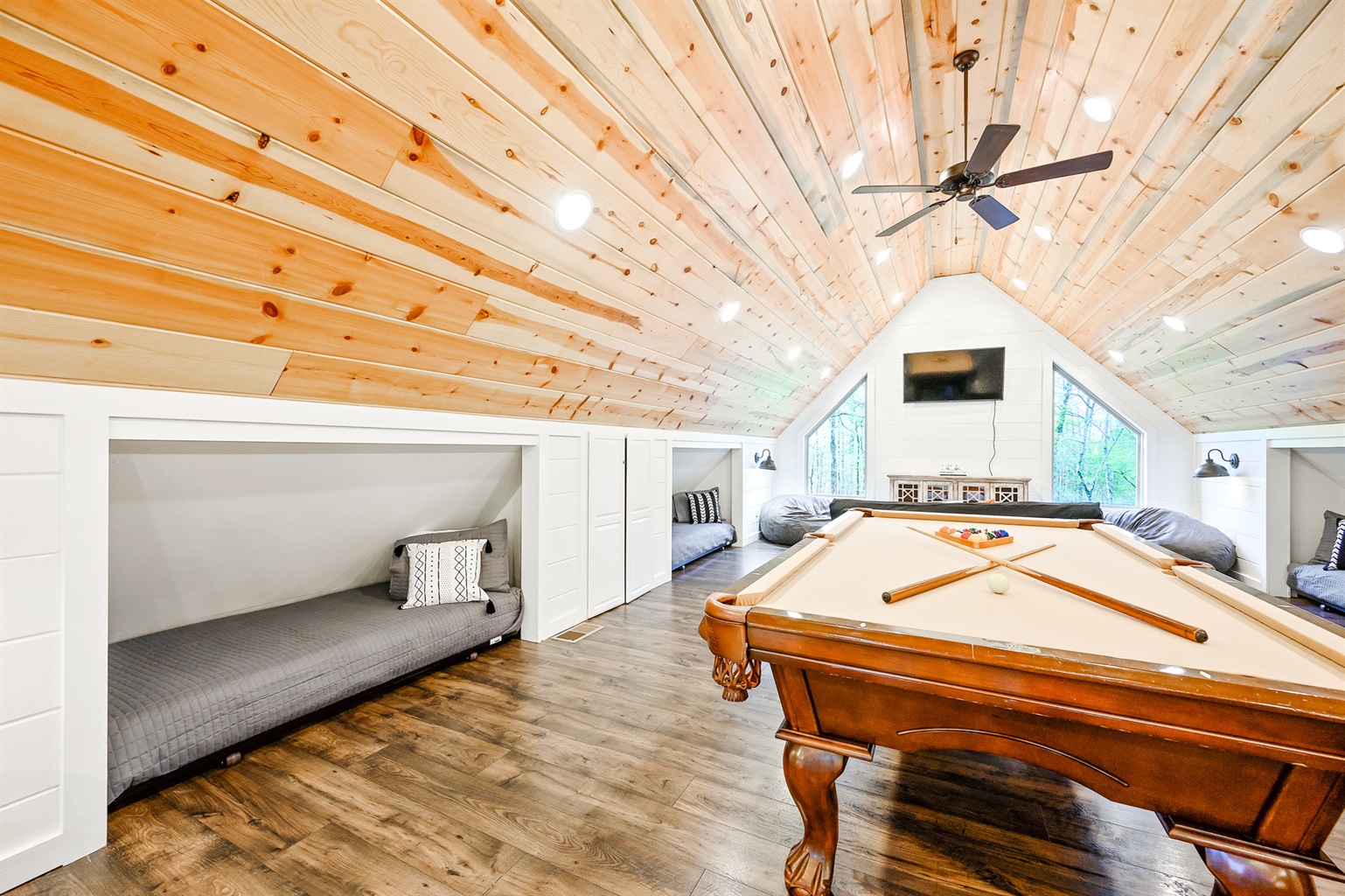 Game loft with pool table, Xbox, smart TV and four twin beds.
