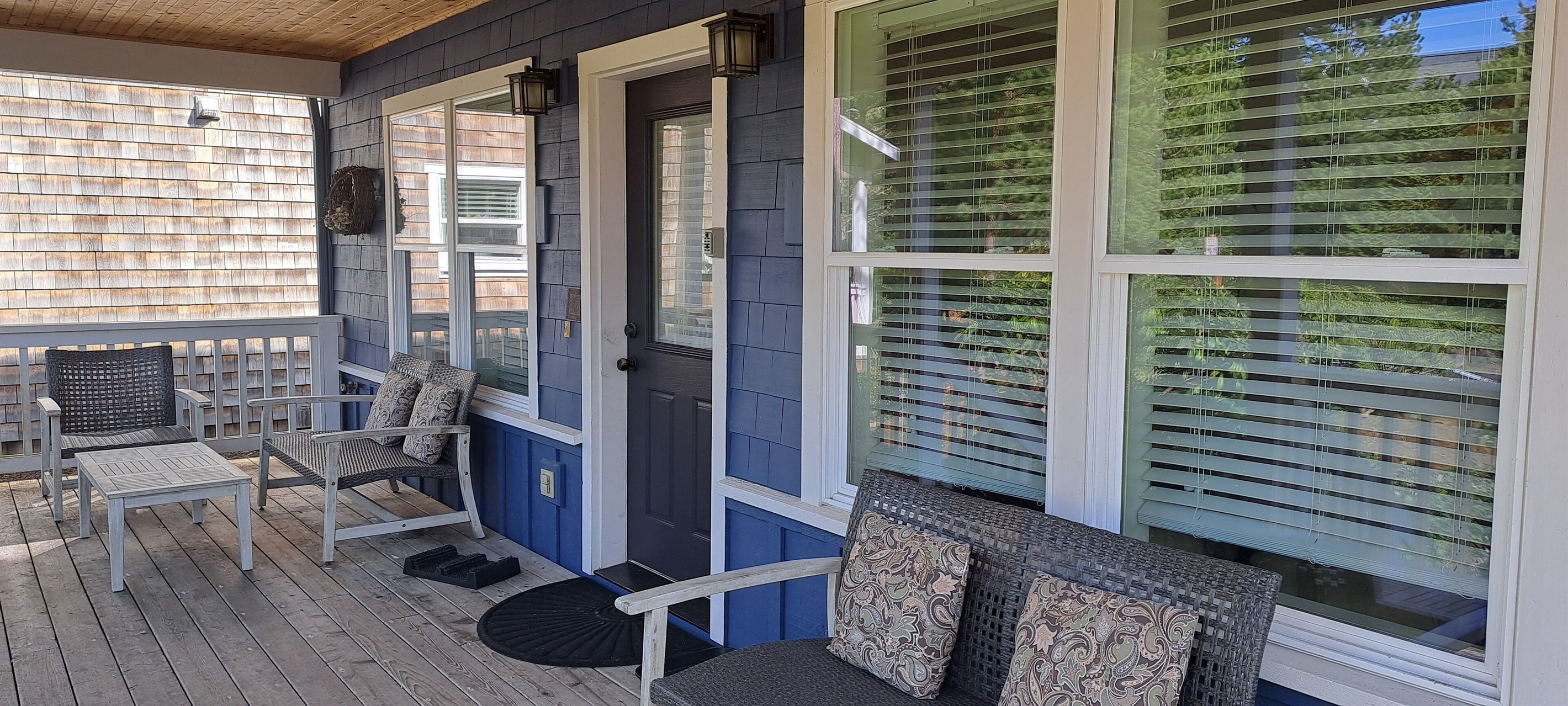 Relax on the covered front porch, complete with plenty of seating for enjoying fresh coastal air.