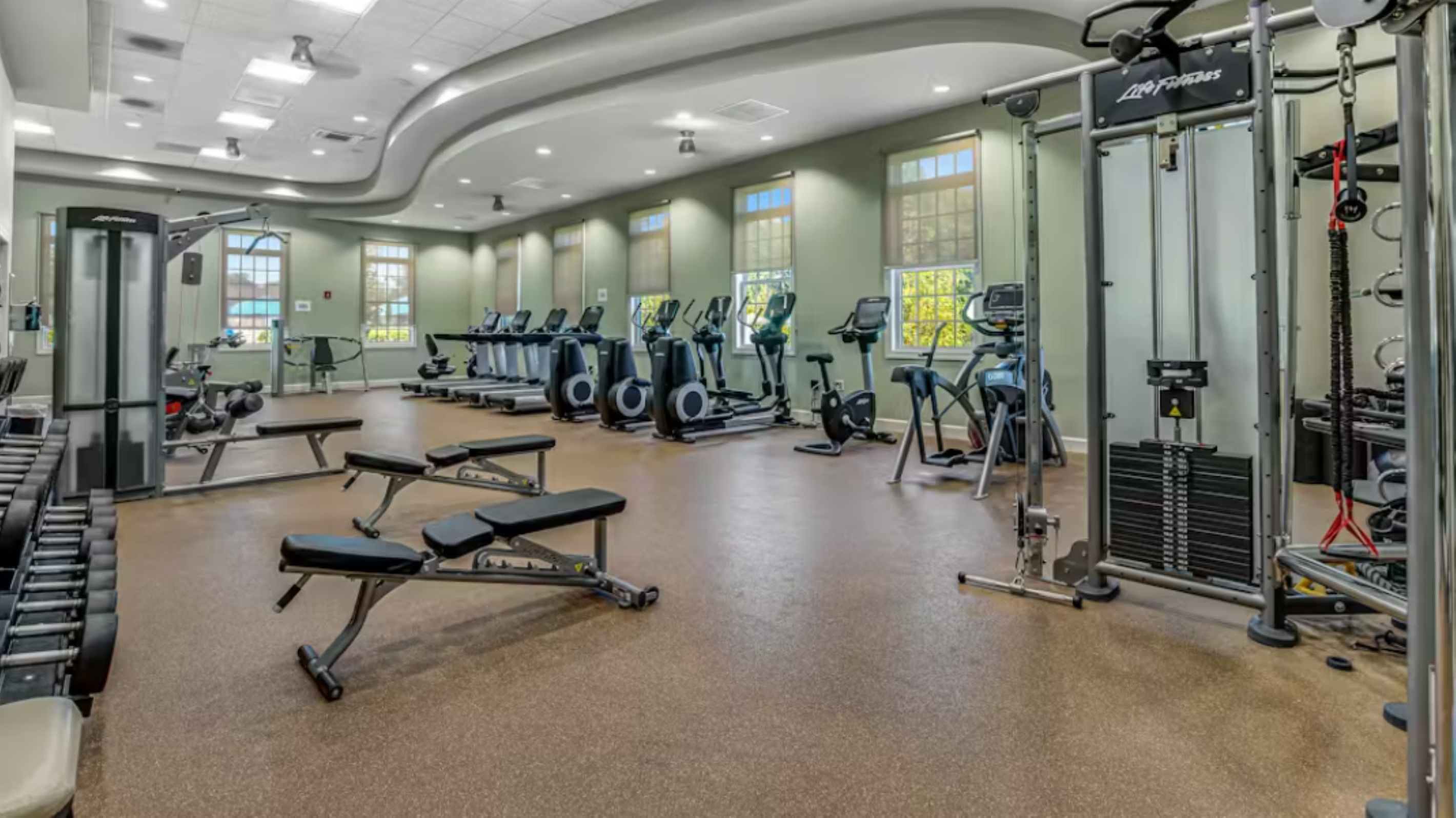 Bright clubhouse gym with cardio machines, free weights, and resistance stations—ideal for every fitness level.