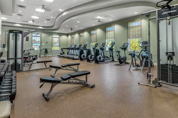 Bright clubhouse gym with cardio machines, free weights, and resistance stations—ideal for every fitness level.