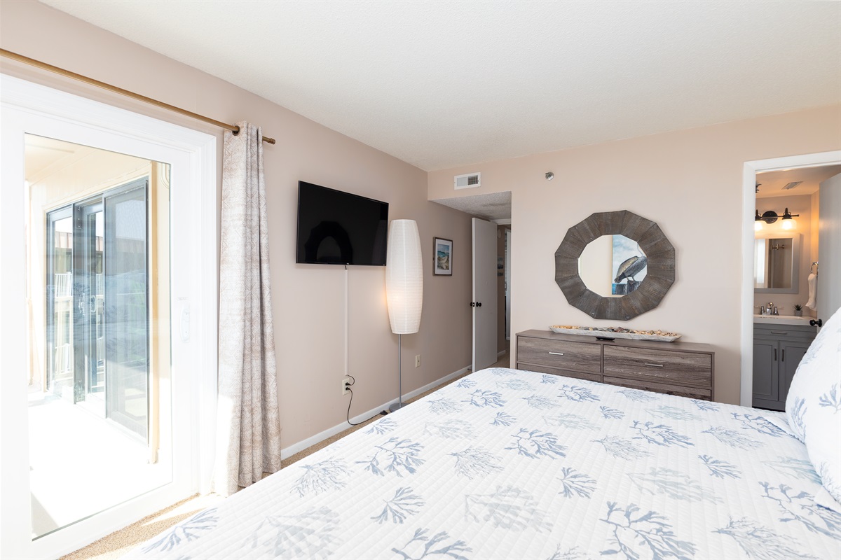 Master bedroom with a view of the outdoors
