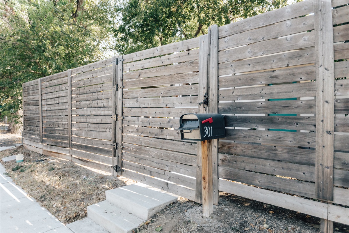 house has big fenced yard , grill