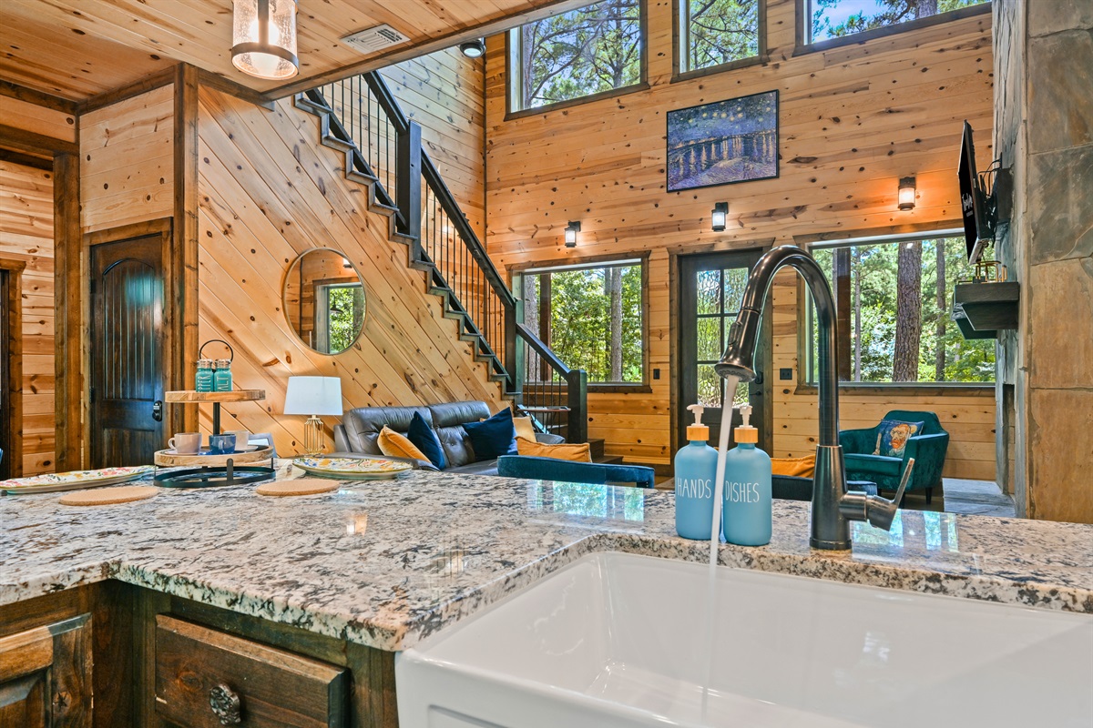 A farmhouse sink and plenty of counter space make it easy to prepare meals while still staying part of the action.