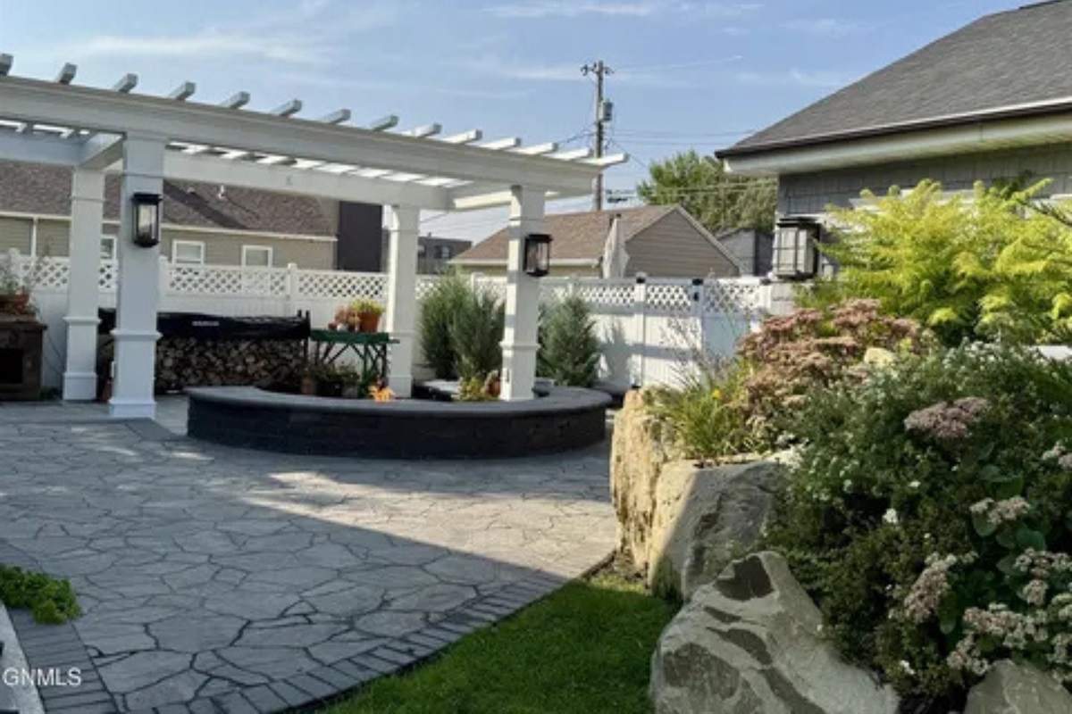 This patio area gives you room to unwind outside with landscaping all around.