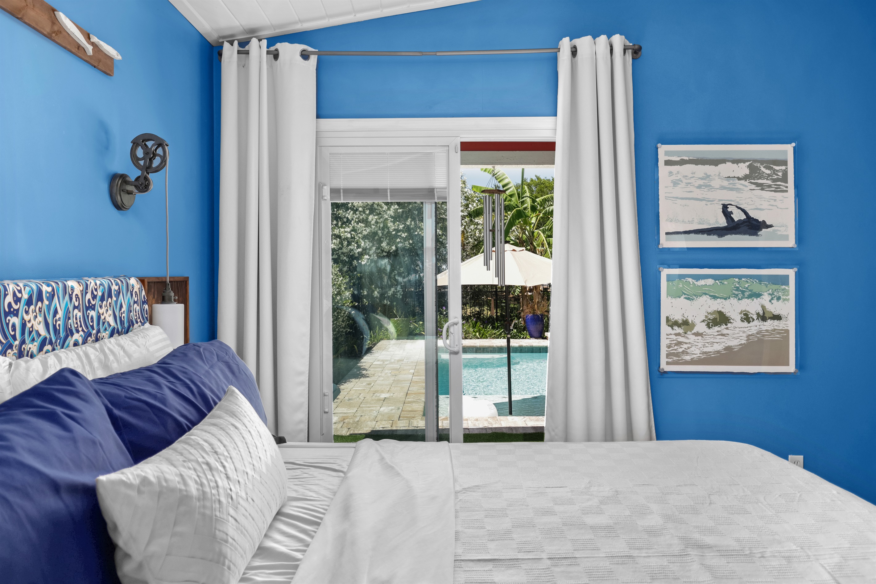 The primary bedroom has pool and garden views.